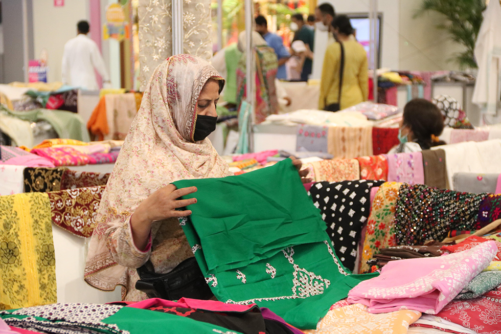 A UN Women beneficiary displays her work at Women Artisan Exhibition in Lahore, Punjab. 