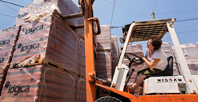Amira Abi Khalil operates a forklift to move palettes of tile. She has owned and operated her brick and stone trading company in Lebanon since 1997. UN Women procures goods and services from women-owned firms such as hers. Photo: UN Women/Joe Saade.